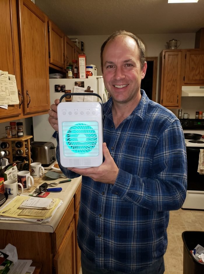 Liam holding his CoolJet in the kitchen